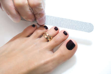 medical pedicure with a nail file. Foot peeling procedure in the spa using a special apparatus. Clinic of Podiatry Podiatry.の写真素材