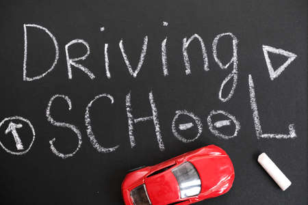 Driving school chalkboard, Educational and Creative composition with the Driving school caption. toy car model. traffic signsの写真素材