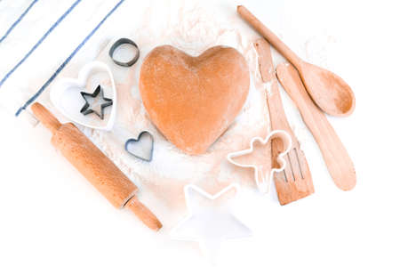 top view of heart shaped dough. Ingredients for baking on white tableの写真素材
