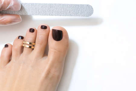 medical pedicure with a nail file. Foot peeling procedure in the spa using a special apparatus. Clinic of Podiatry Podiatry.の写真素材