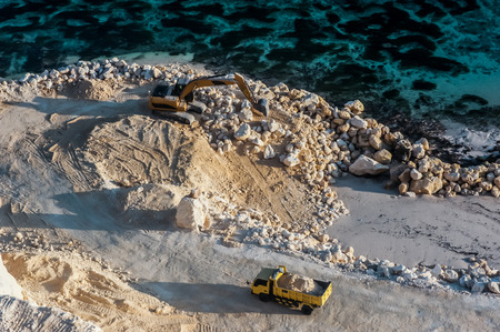 Construction process of the road next to the ocean. Calicium rock formation is used as a background for the future road.の写真素材