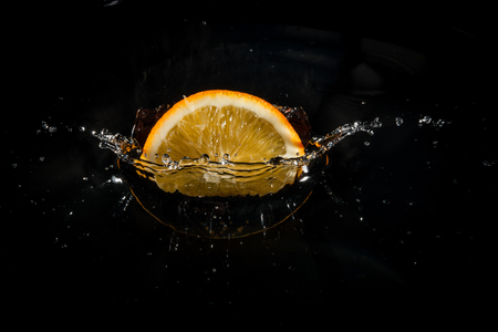 fresh orange writing falls into the waterの写真素材