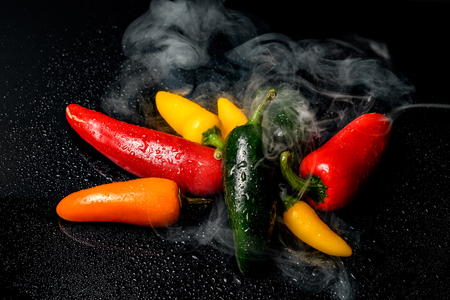 spicy red chilli shrouded in smokeの写真素材