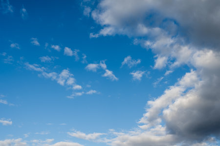Blue sky background with white clouds. Cumulus white clouds in the blue sky.の写真素材