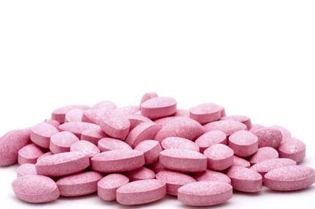 Pink Medicine Tablets on White Low Angle