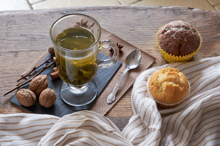 Hot green tea and fresh muffins.の写真素材