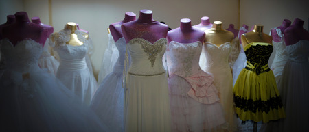 Dresses and mannequins awaiting sale in the back roomの写真素材
