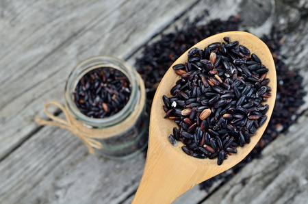 black rice on wooden tableの写真素材