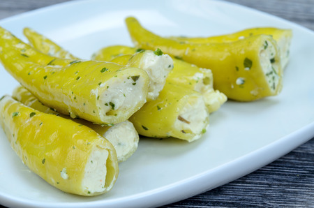 green pepper in dish on gray wooden tableの写真素材