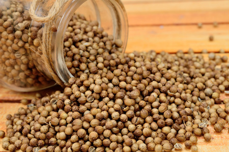 coriander seed on wooden tableの写真素材
