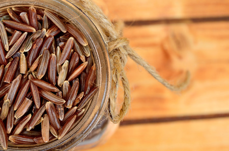red rice on wooden tableの写真素材