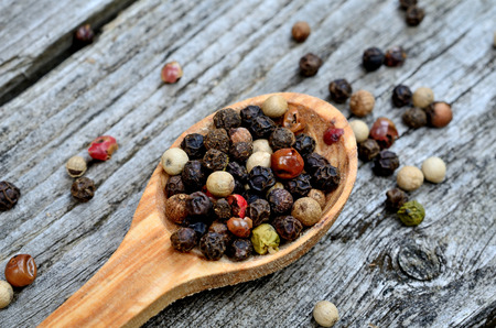 peppercorn in spoon on wooden tableの写真素材