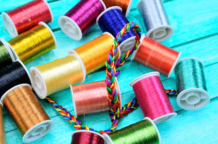 color sewing thread on blue wooden table