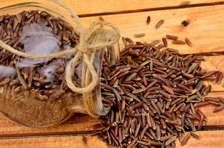 red rice on wooden tableの写真素材