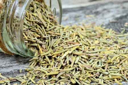 dried rosemary on wooden tableの写真素材