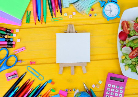 board and supplies for school on yellow wooden tableの写真素材
