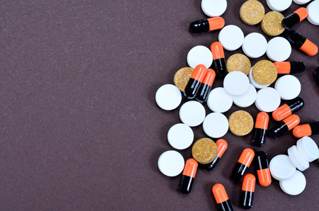 pills on brown table