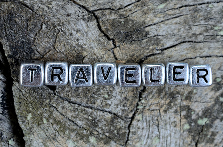 silver word traveler on cracked wooden tableの写真素材