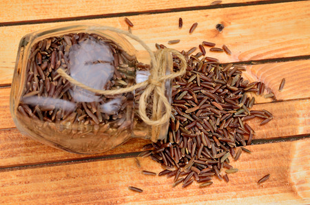 red rice on wooden tableの写真素材