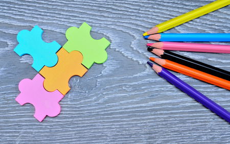 color pencil and puzzle on gray wooden tableの写真素材