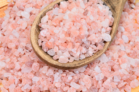 pink salt on brown wooden tableの写真素材