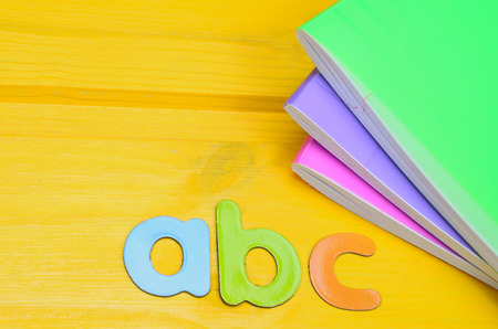 letter abc on yellow wooden tableの写真素材