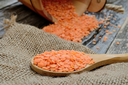 red lentil in spoon on sackの写真素材