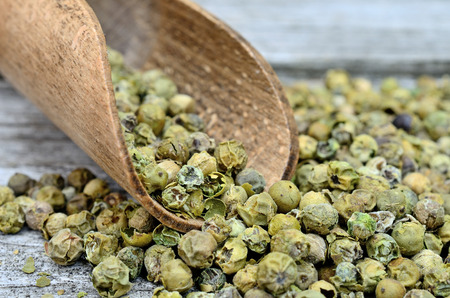 green peppercorn on wooden tableの写真素材