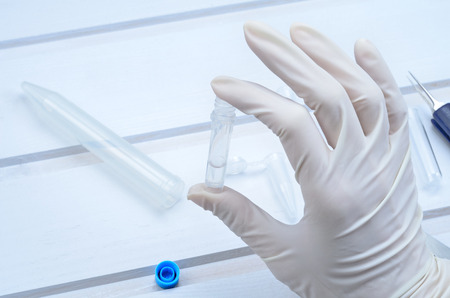 hand hold a tube with liquid in laboratoryの写真素材