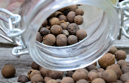 allspice in jar on wooden tableの写真素材