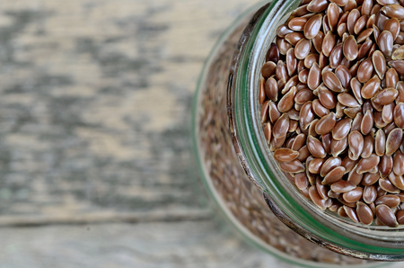 jar with flaxseed on wooden tableの写真素材