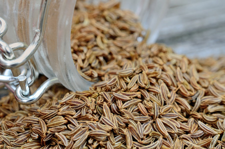 caraway in jar flow on wooden tableの写真素材