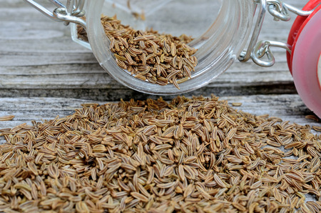 caraway in jar flow on wooden tableの写真素材