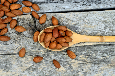 almond in spoon on wooden tableの写真素材