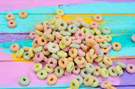 pile of color cereal on multicolored wooden table