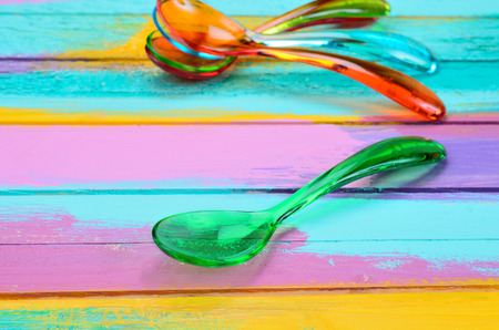 color spoon on multicolored wooden tableの写真素材