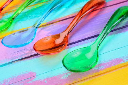 color spoon on multicolored wooden table