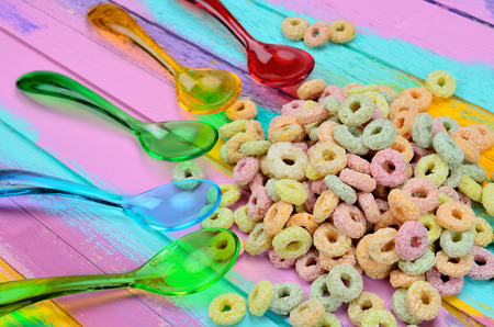 color spoon with cereal on wooden tableの写真素材