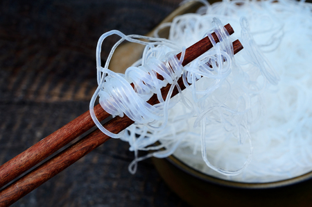 chinese noodle in pot on black wooden tableの写真素材
