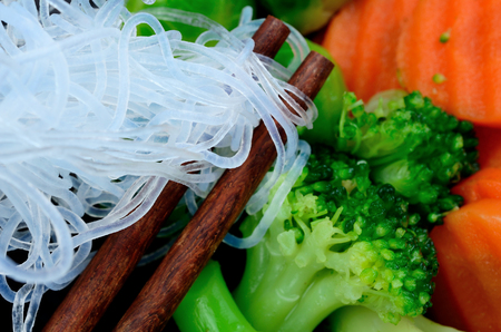 chinese noodle with vegetables on black wooden table