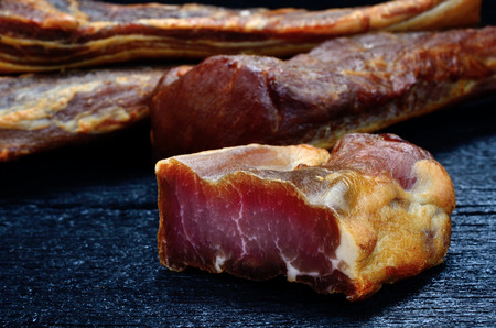 smoked meat on black wooden tableの写真素材