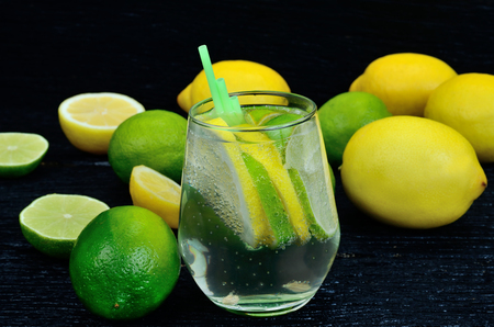 glass of water with lemon and lime for detox on  tableの写真素材