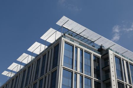 Modern business centre on blue sky with clouds
