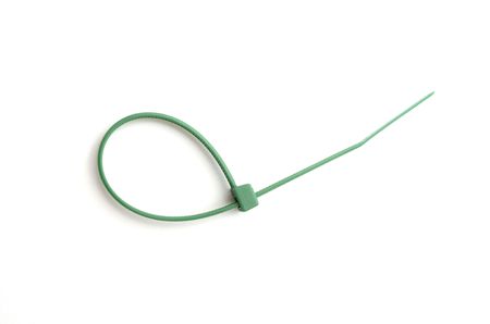 Green nylon cable tie on white backgroundの写真素材