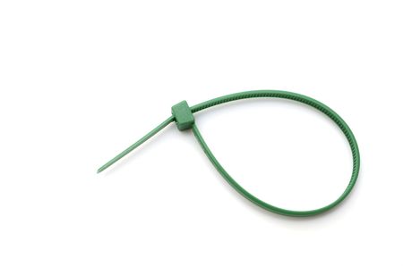 Green nylon cable tie on white backgroundの写真素材