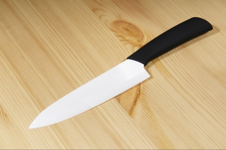 White ceramic knife on wood backgroundの写真素材