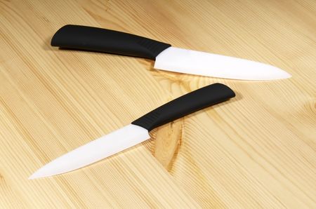 Set of white ceramic knives on wood backgroundの写真素材