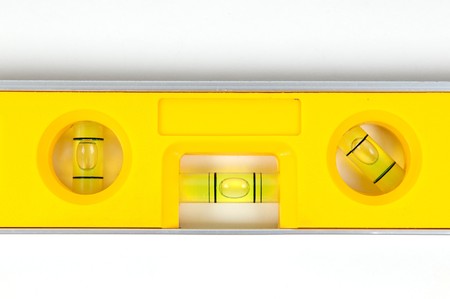 Yellow spirit level isolated on a white backgroundの写真素材