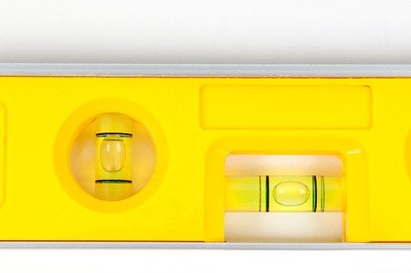 Yellow spirit level isolated on a white backgroundの写真素材