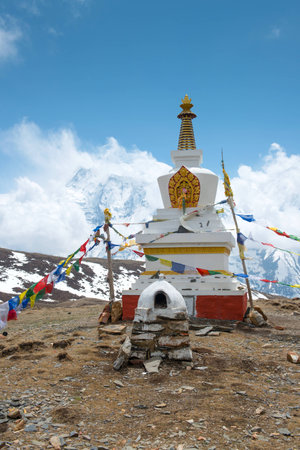 Buddhist stupa with colorful flags on a Annapurna Circuit - most popular turists trek in Himalayan mountain massive in Nepal.の写真素材